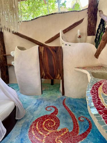 a room with a snake on the floor at Ikalar in Akumal