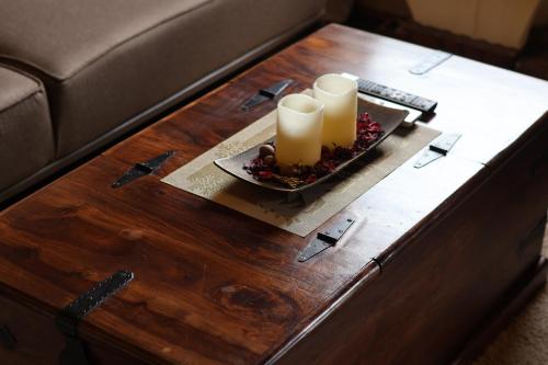 a coffee table with two candles on top of it at Portes du Soleil - Zabljak in Žabljak
