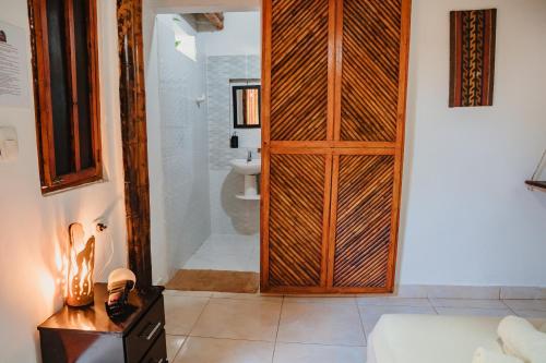 a bathroom with a large wooden door in a room at Kasakolà in Palomino