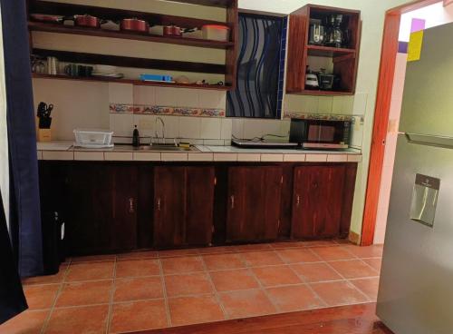 a kitchen with a sink and a counter top at Villas Kiki in Puerto Viejo