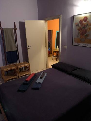a bedroom with a bed with a black comforter at Casa accogliente sul naviglio in Milan