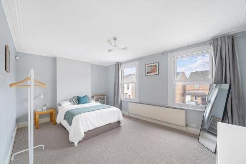 a bedroom with a bed and a window at Beautiful Large Bedrooms in South Norwood