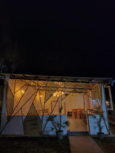 a view of a house at night with lights at Paradise Pool Resort in Nainital
