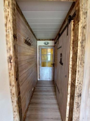 a hallway in a house with wooden walls at DOMAINE DE LA LUCARLIERE in Saint-Cyr-des-Gâts