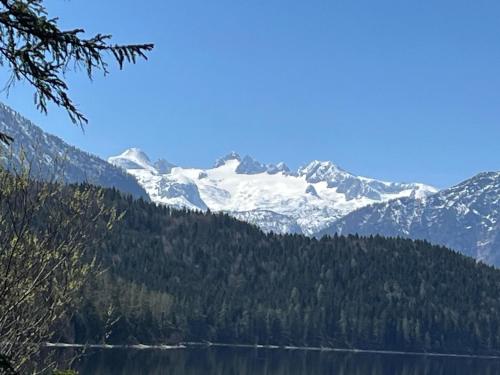 a snow covered mountain with a lake in the foreground at Ferienhaus Valentina in Grundlsee