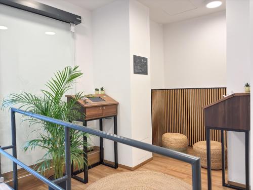 a staircase with a potted plant and a table at Brunnen Apartments in Nürnberg