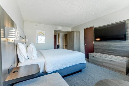 a hotel room with a bed and a flat screen tv at Holiday Inn Express Philadelphia Penn's Landing by IHG in Philadelphia