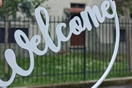 a metal sign that says synergy in front of a fence at Friendly Home 3 trilocale in Sedriano