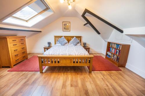 a bedroom with a bed and a skylight at Cosy Llandudno Apartments in Llandudno