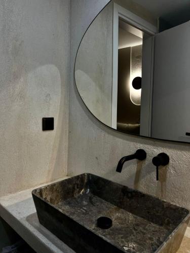 a bathroom with a sink and a mirror at Vabel Skiathos in Skiathos Town