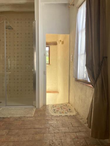 a bathroom with a shower and a glass door at Sur Les Ailes du Papillon-Le Duplex in Saint-Sauveur-en-Puisaye