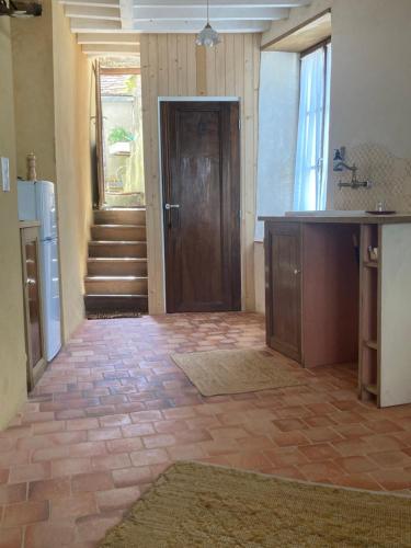 a room with a hallway with a door and a staircase at Sur Les Ailes du Papillon-Le Duplex in Saint-Sauveur-en-Puisaye
