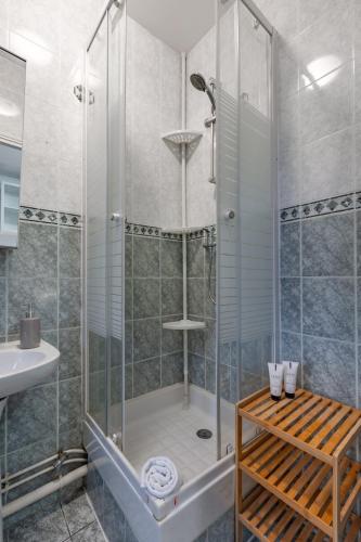une salle de bain avec douche et lavabo dans l'établissement Cozy studio near Montparnasse, à Paris