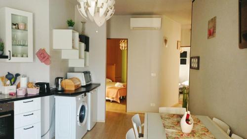 a kitchen with a table and a dining room at Residence Pool Peschiera del Garda in Peschiera del Garda