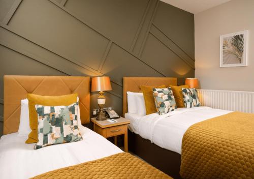 two beds sitting next to each other in a room at Breaffy House Hotel and Spa in Castlebar