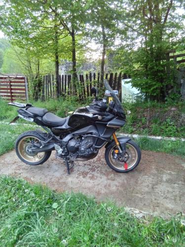 a black motorcycle parked in a yard at Casa Ozon in Vulcan