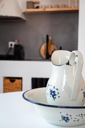 a tea pot on a plate on a kitchen counter at Living Blue Tinos in Kardiani