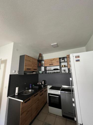 a small kitchen with a sink and a refrigerator at Kuća za odmor Ana in Oklaji