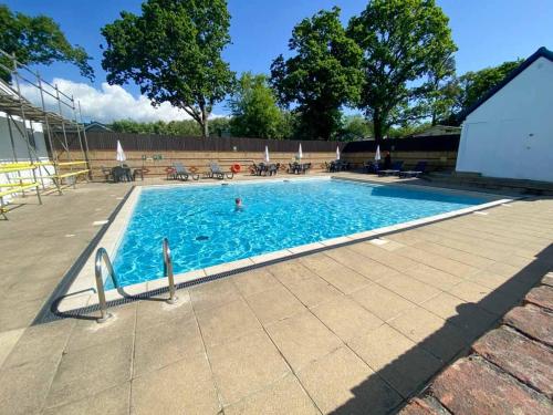 a large swimming pool with a person in the water at Island Retreat in Sandown