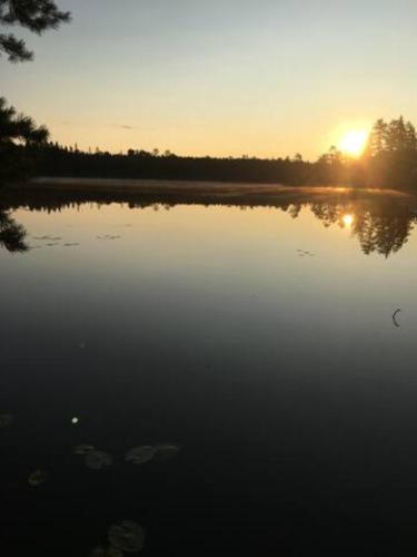 a large body of water with the sun setting in the background at Rent your own island! in Lersjötorp