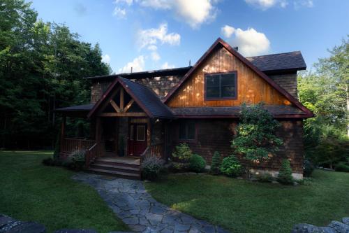 a log home with a gambrel roof at Luxury Chalet, Firepit, Sauna, Pet Friendly, 5 mins to Windham Mtn resort in Windham