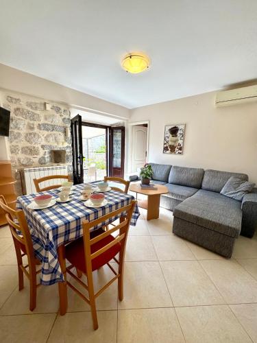 a living room with a table and a couch at Apartments Radonicic in Kotor