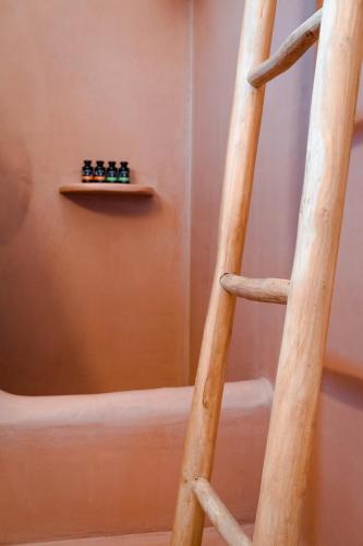 a wooden ladder in a room with a shelf at Living Blue Tinos in Kardiani