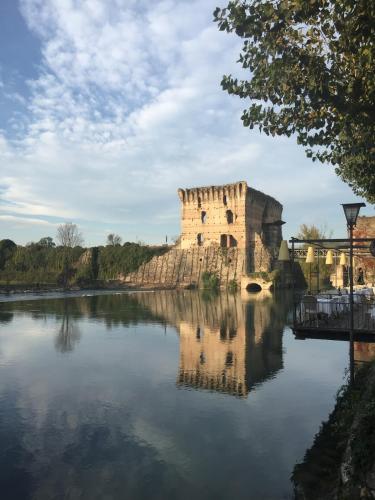 an old castle sitting on top of a lake at Art&Castle View 5 min from Sigurtà Park in Valeggio sul Mincio