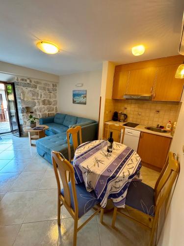 a kitchen and a living room with a table and chairs at Apartments Radonicic in Kotor