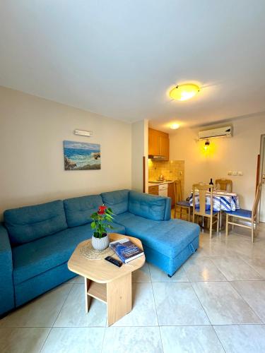 a living room with a blue couch and a table at Apartments Radonicic in Kotor
