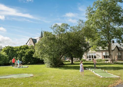 a little girl standing in the grass in a park at Breaffy House Hotel and Spa in Castlebar