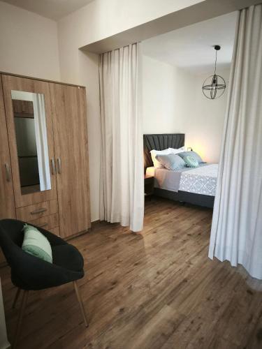 a bedroom with a bed and a chair at Amazing View Studio in Chorepískopoi
