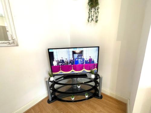 a television sitting on a stand in a room at Bude A2 - CosySaver in Belle Isle