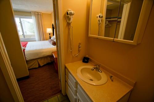 a bathroom with a sink and a phone in a room at The Villages of Loon Mountain Fixed in Lincoln