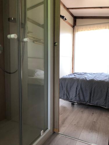 a glass door leading to a bedroom with a bed at Manoir de Champvert in Les Vans