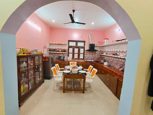 a dining room with a table and chairs in a kitchen at Sneh Homestay in Ayodhya