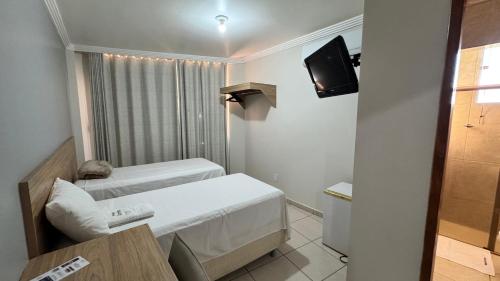 Ένα ή περισσότερα κρεβάτια σε δωμάτιο στο Hotel Carreiro Inhapim