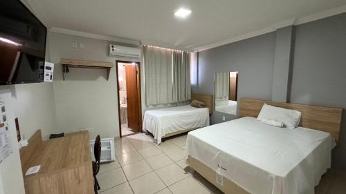 Ένα ή περισσότερα κρεβάτια σε δωμάτιο στο Hotel Carreiro Inhapim