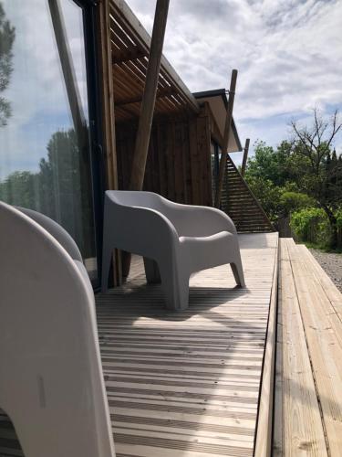a white bench sitting on top of a wooden deck at Manoir de Champvert in Les Vans