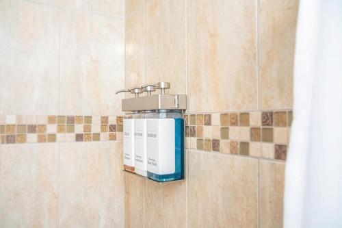 a soap dispenser on a wall in a bathroom at The Local - St. Augustine in St. Augustine
