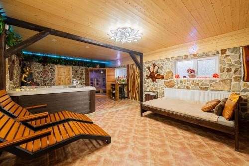 a bedroom with a bed and a tub in a room at Wellness Apartment Medusa in Hamr na Jezeře