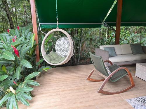 a patio with a swing and a chair and a couch at Residência Executiva de Alto Padrão - COP30 in Benevides