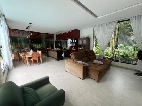 a living room with a couch and a table at Residência Executiva de Alto Padrão - COP30 in Benevides