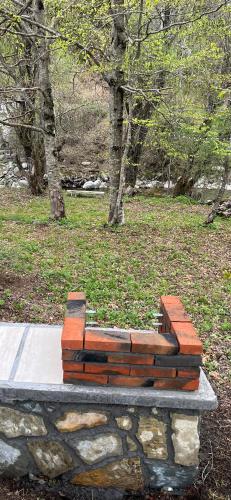 a wooden bench sitting on top of a stone wall at Holiday Home Veruša in Podgorica