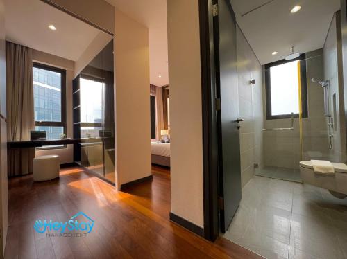 a bathroom with a glass shower and a toilet at 8 Kia Peng Suites KLCC By HeyStay Management in Kuala Lumpur