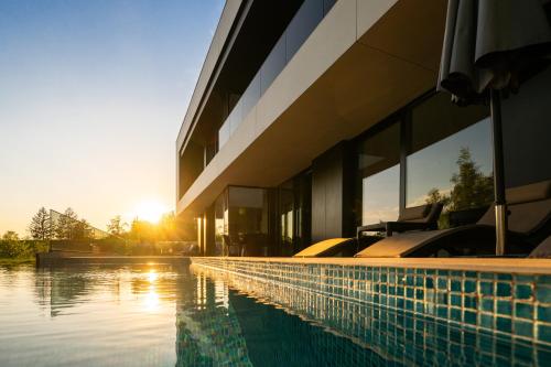 a house with a swimming pool next to a building at The Villa O in Sarajevo