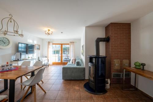 a kitchen and living room with a wood stove at Ferienhof am Trift in Bad Saarow