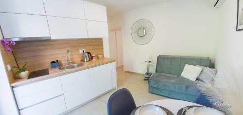 a kitchen with a sink and a couch in a room at Stari View-Free Parking in Mostar