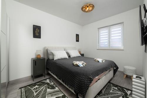 a bedroom with a bed and a window at Apartment Grey in Medulin