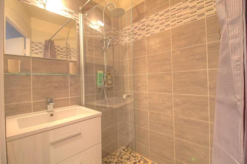 une salle de bain avec un lavabo et une douche dans l'établissement Cosy 2 pièces dans résidence avec piscine, à Antibes